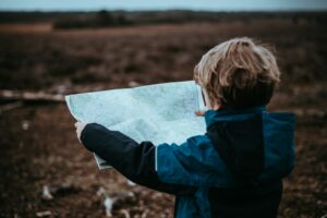 Photo by Annie Spratt child looking at map